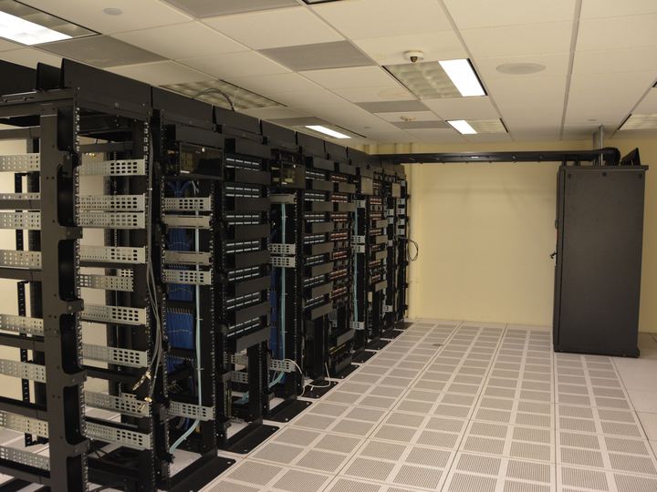 Rows of server racks with blinking lights inside a data center
